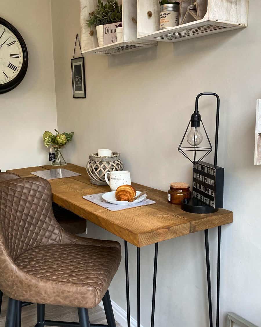 Cozy breakfast bar with a rustic wooden table, quilted leather barstools, industrial-style lighting, and farmhouse-inspired decor for a warm ambiance