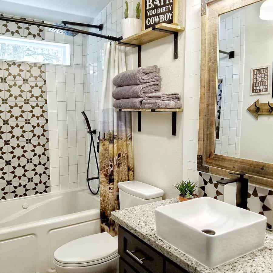 Rustic bathroom with patterned tile backsplash, wood-framed mirror, vessel sink, and western-themed decor for a cozy farmhouse vibe.