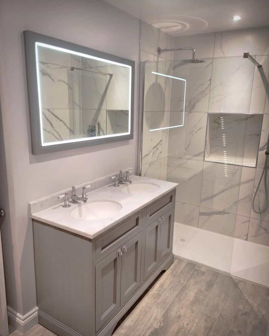 Elegant bathroom with illuminated mirror and double vanity