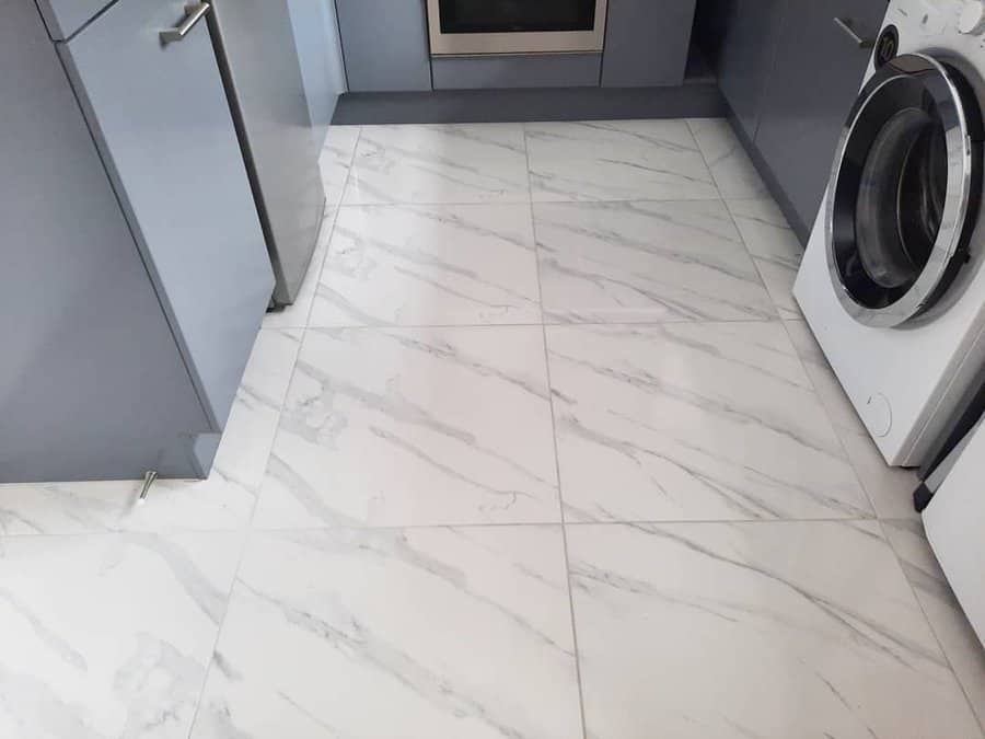 White kitchen with marble flooring