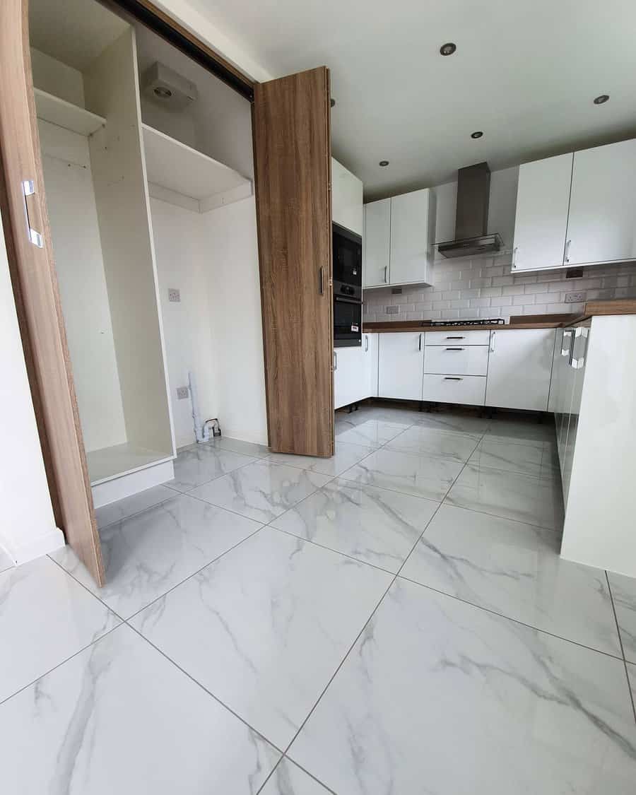 white kitchen with marble flooring