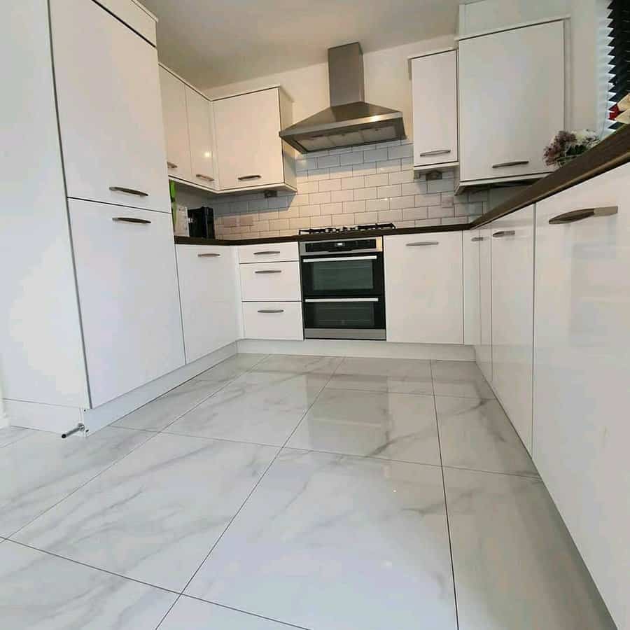 White kitchen with marble flooring