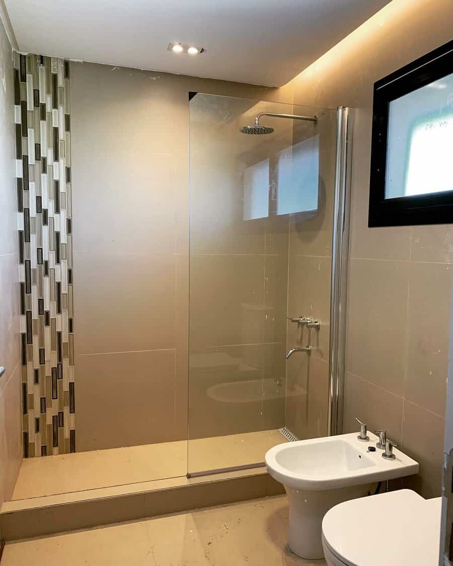 Modern bathroom with beige tiles and bidet