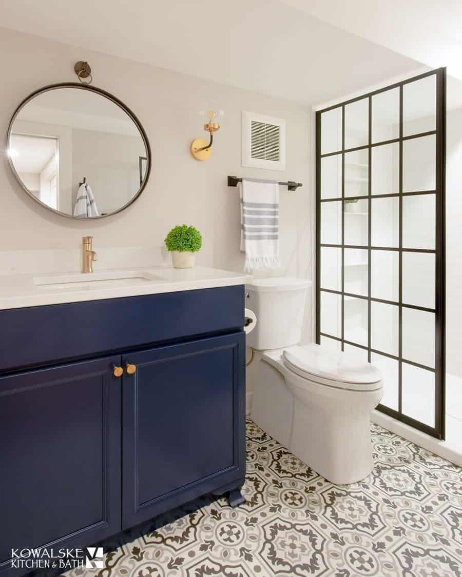 Chic bathroom with patterned tiles and navy vanity