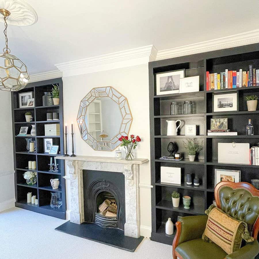 A classic marble fireplace with a black insert, framed by elegant shelving and a geometric mirror above, offering a sophisticated and cozy atmosphere