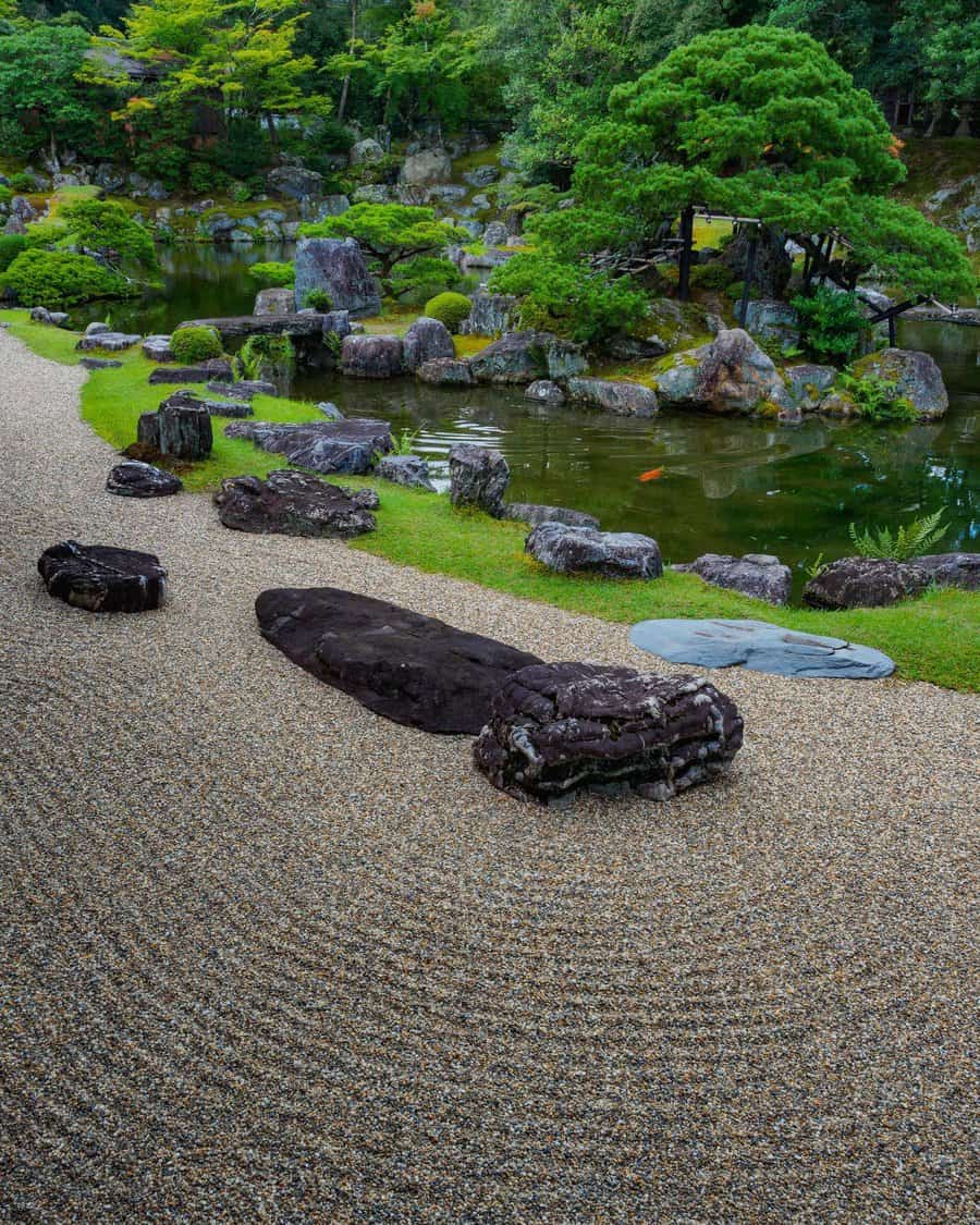 A tranquil Japanese zen garden with raked gravel patterns, rocks, and a pond surrounded by lush green trees