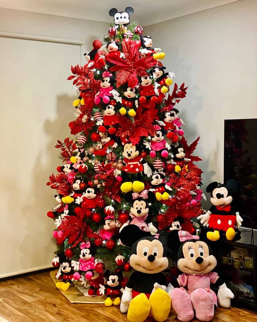 Christmas tree adorned with numerous Mickey and Minnie Mouse plush toys and decorations