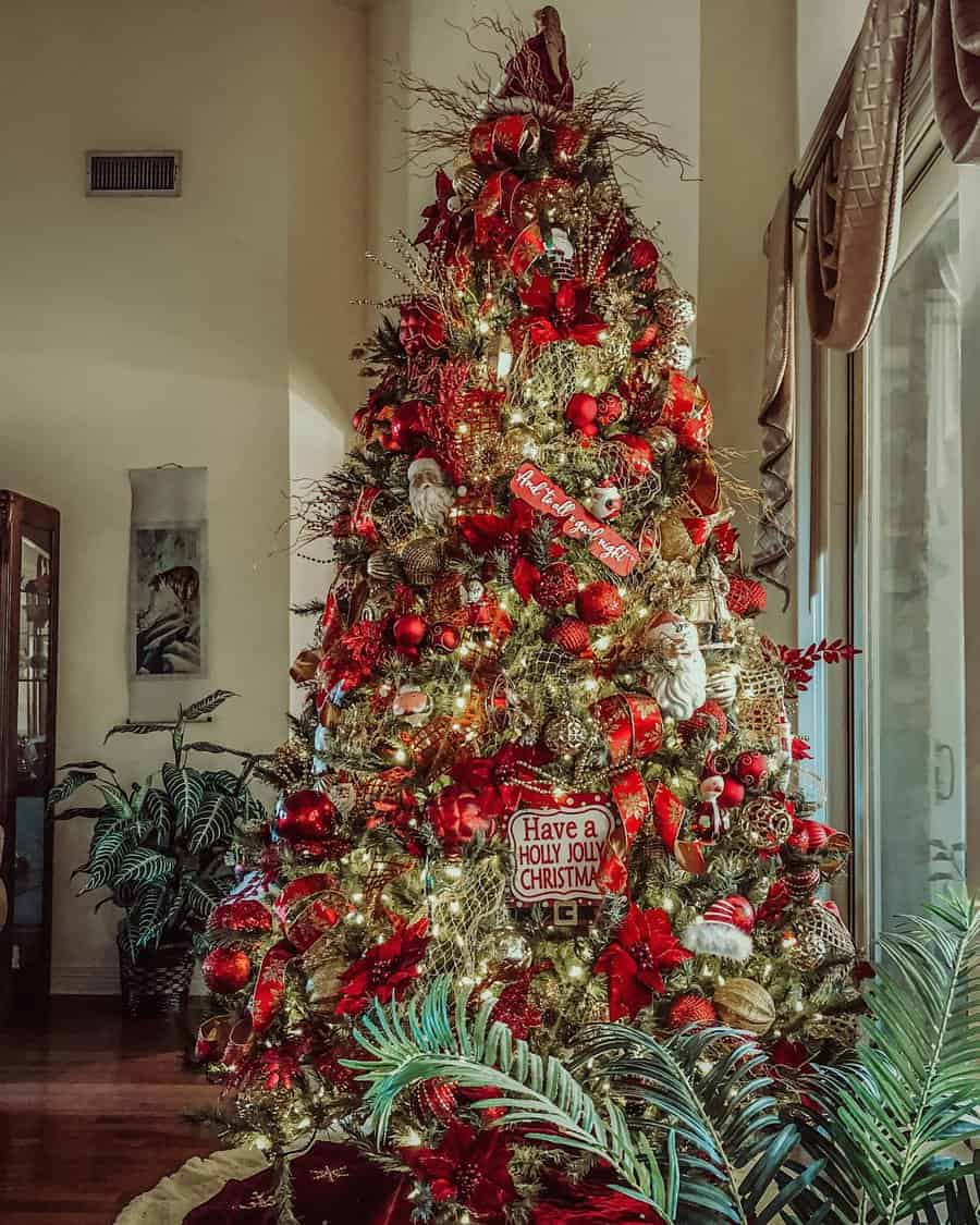 A tall Christmas tree lavishly decorated with red and gold ornaments and lights