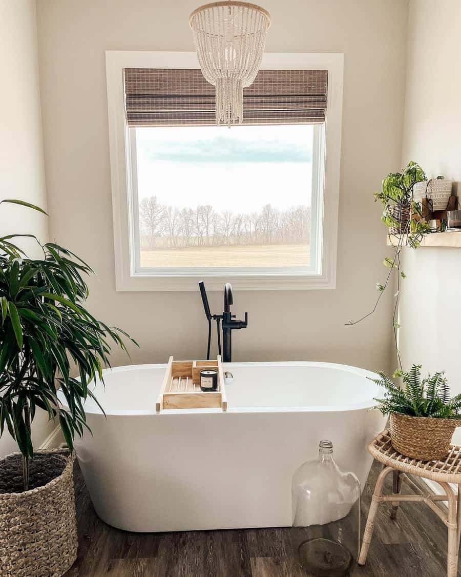 Serene bathroom with freestanding tub and rural view