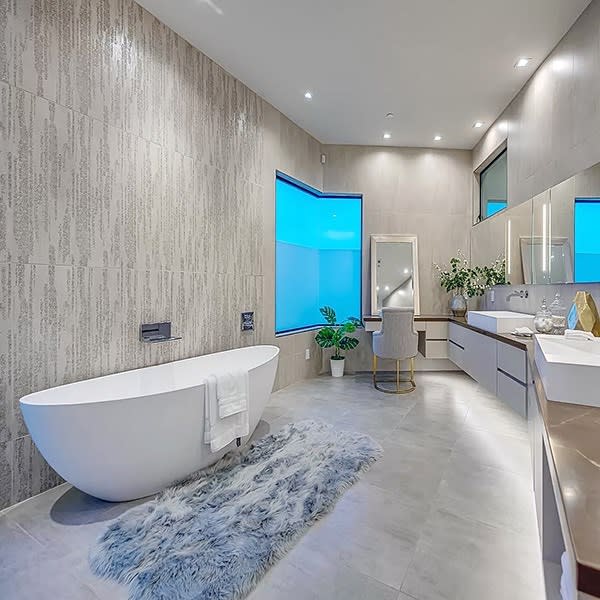 Modern bathroom with textured walls and blue window