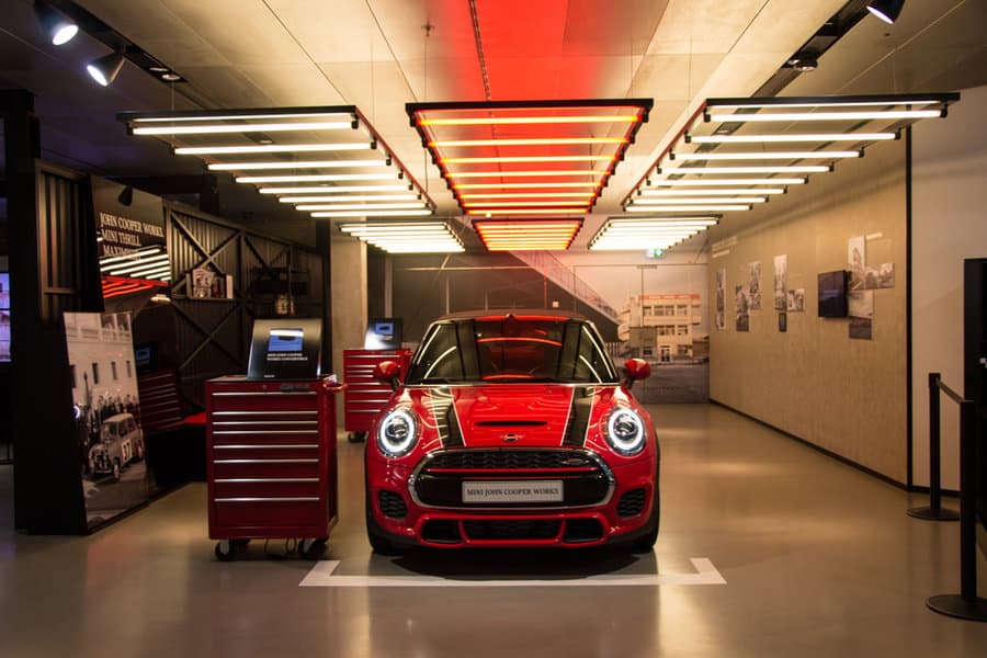 Red Mini Cooper showcased under dramatic lighting