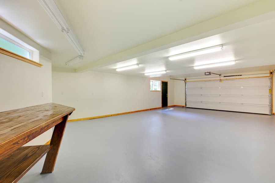 Empty garage with fluorescent lighting and workbench