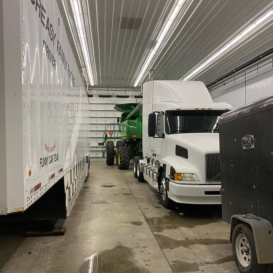 Truck and machinery in a garage with tube lighting