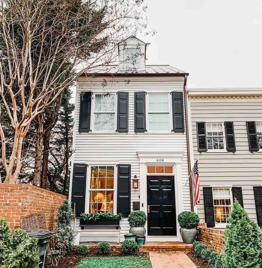 White colonial house with shiplap walls