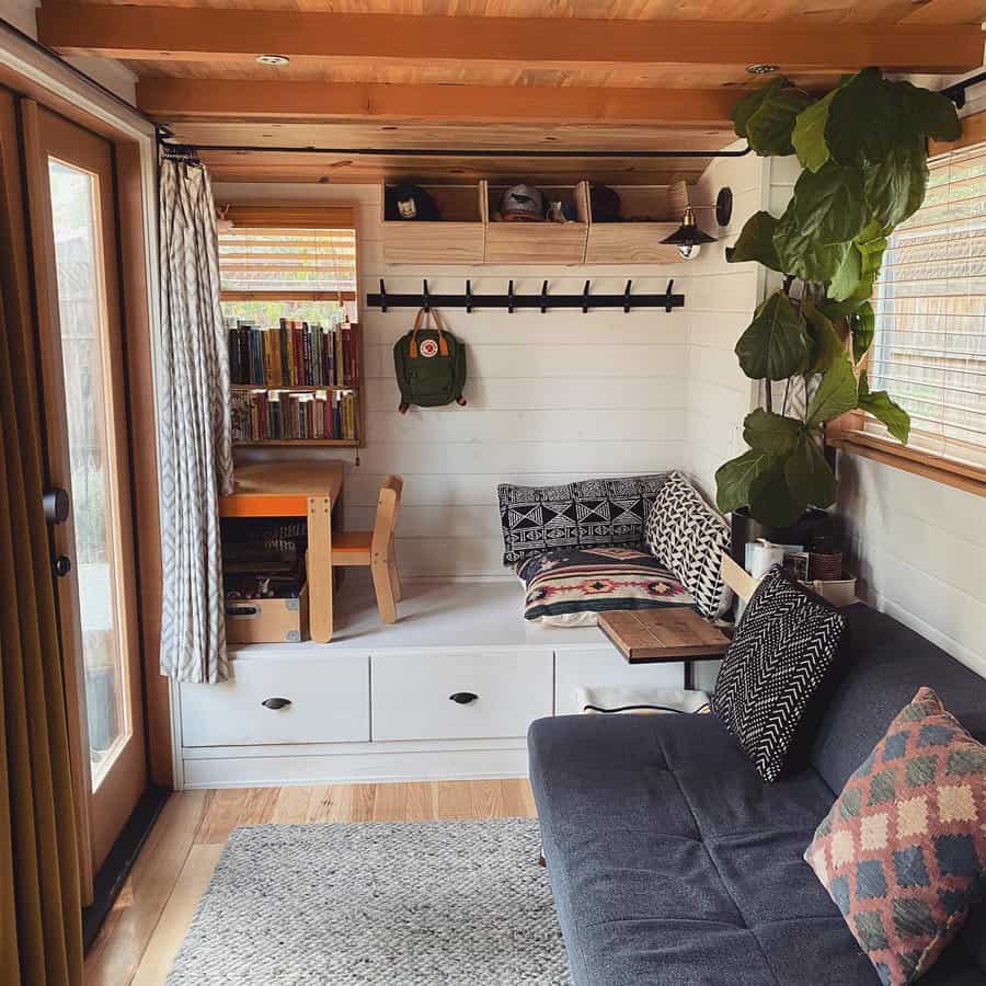 A little living area with a couch and bookcase by the main door