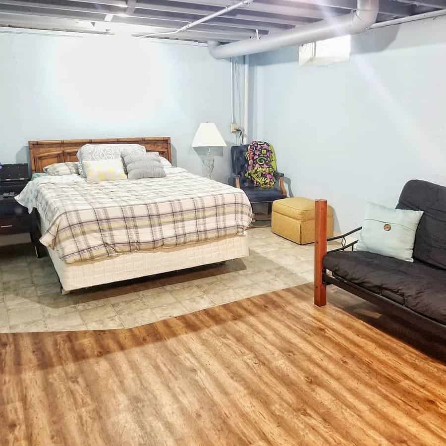 Spacious basement bedroom with wood furnishings and seating area