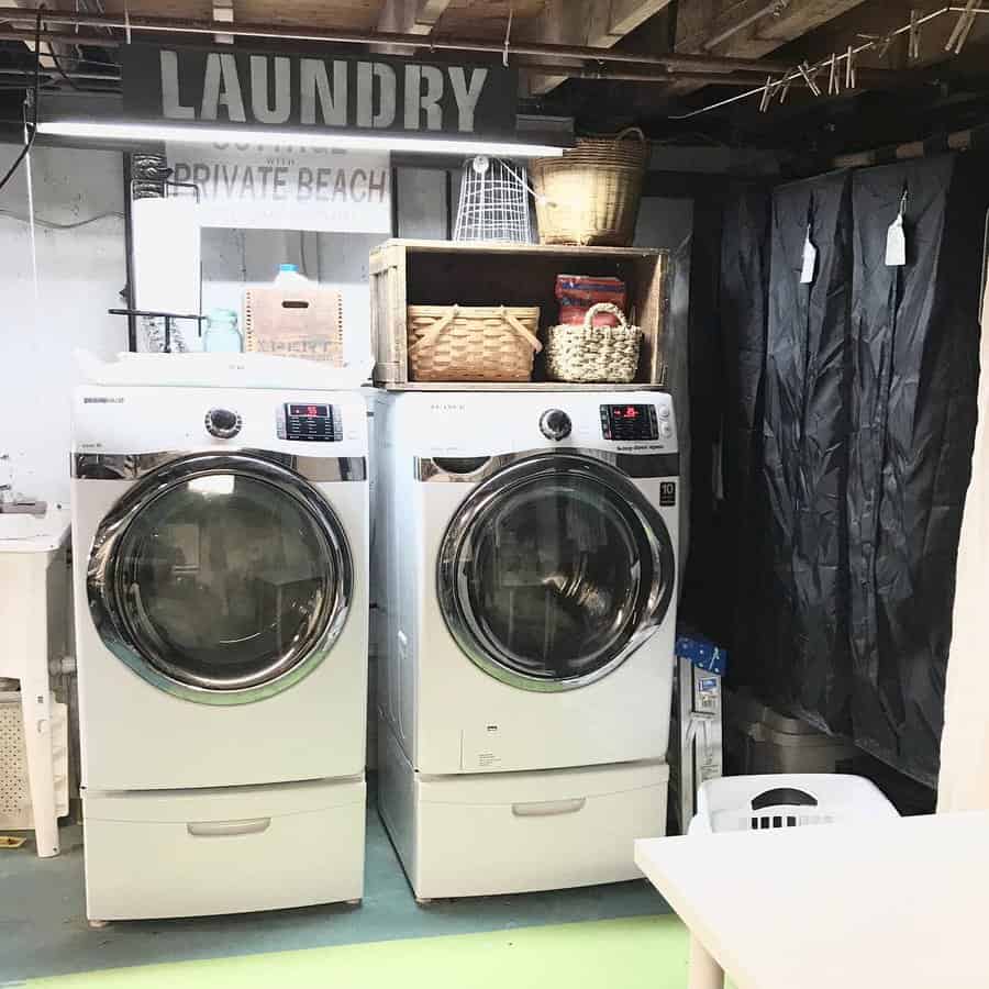 Basement laundry with wooden wall art 