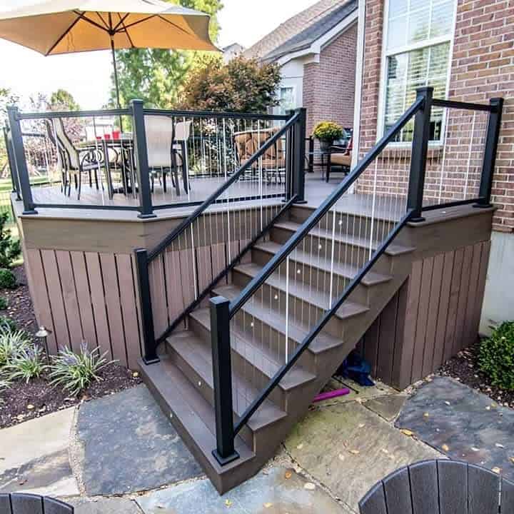 Elevated deck with black railings and umbrella