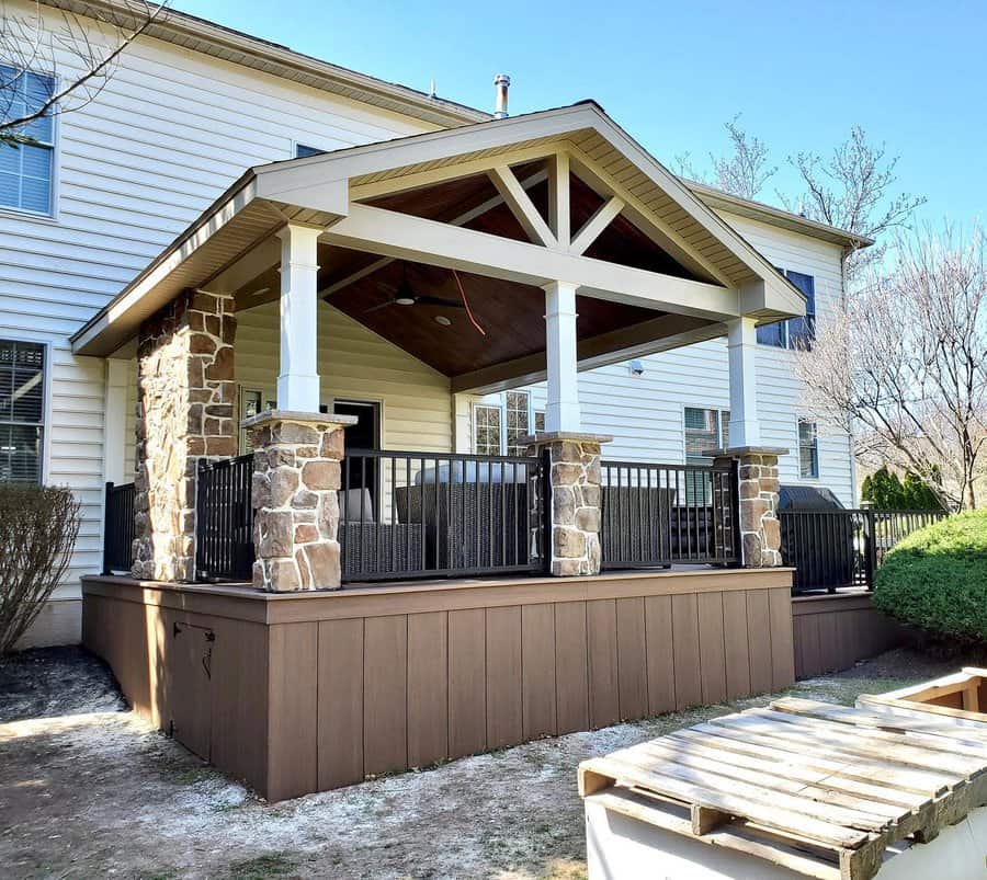 Porch with stone pillars and dark skirting