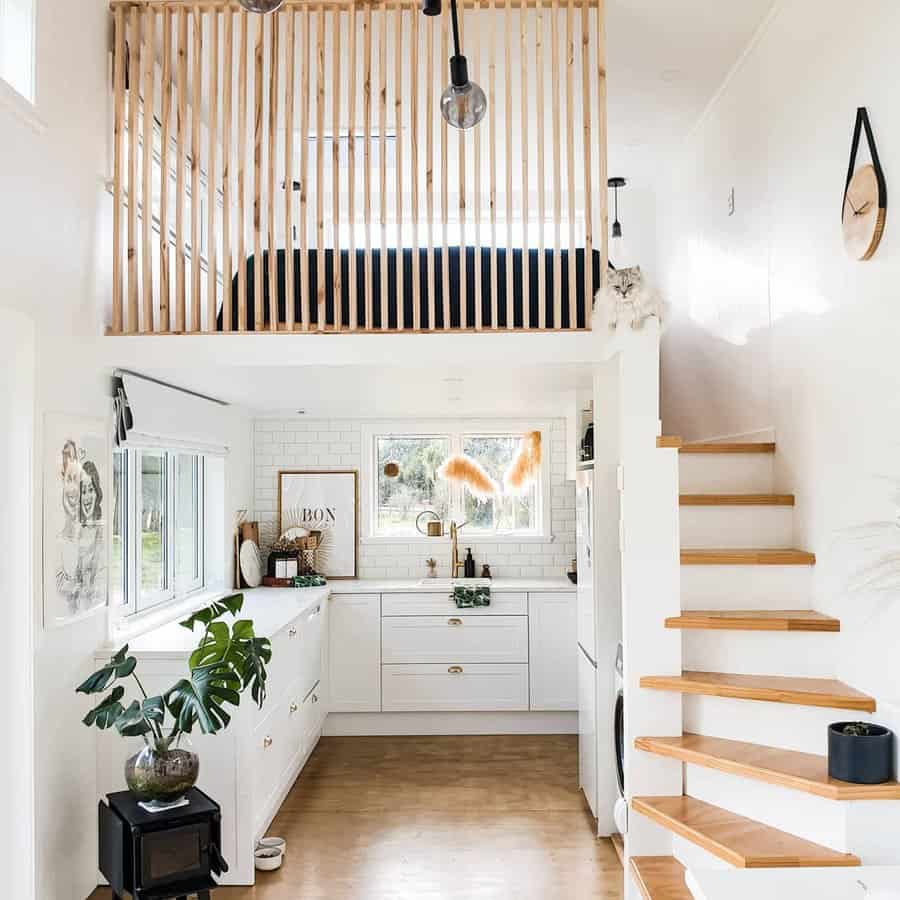 Bright kitchen with vertical loft railings and stairs