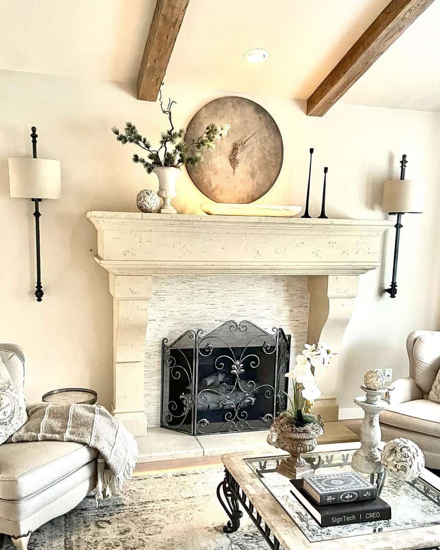 A cozy living room with a stone fireplace, decorative mantel, sofas, and a coffee table in neutral tones and a serene atmosphere