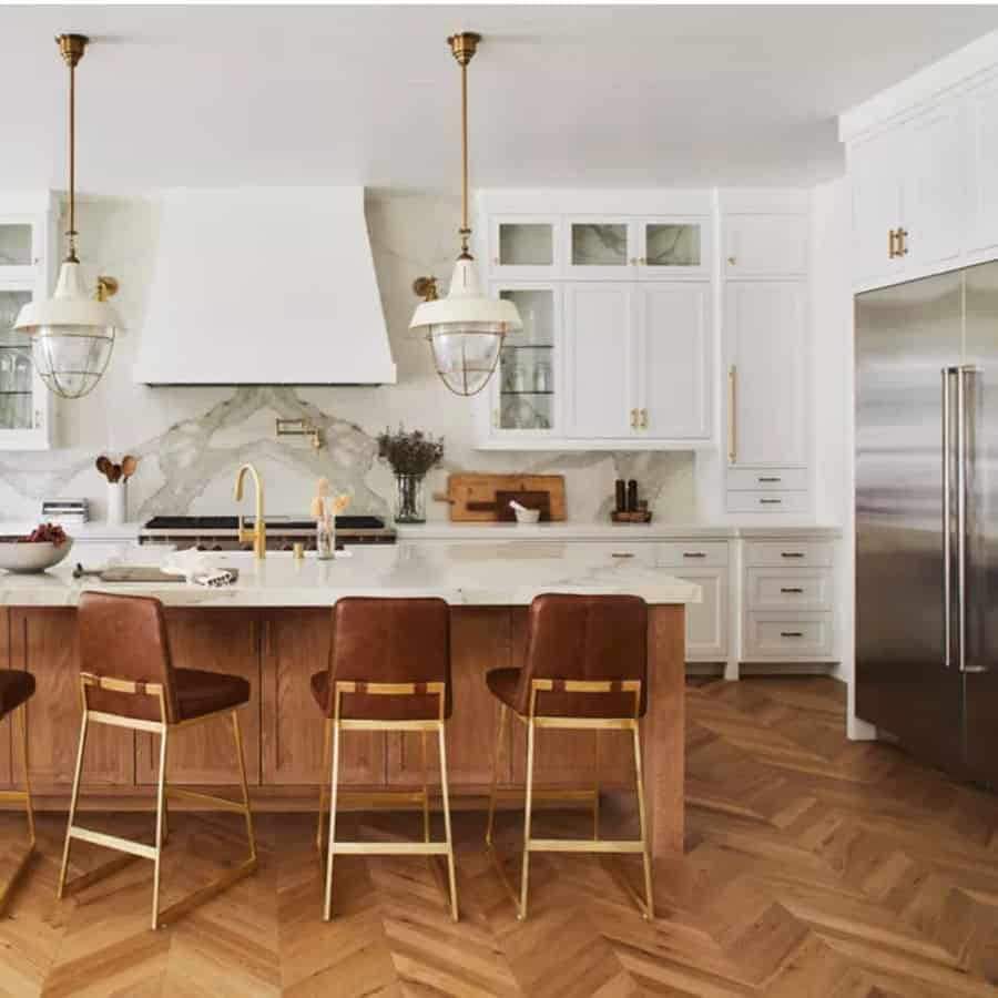 Chic kitchen with herringbone floor and brass accents