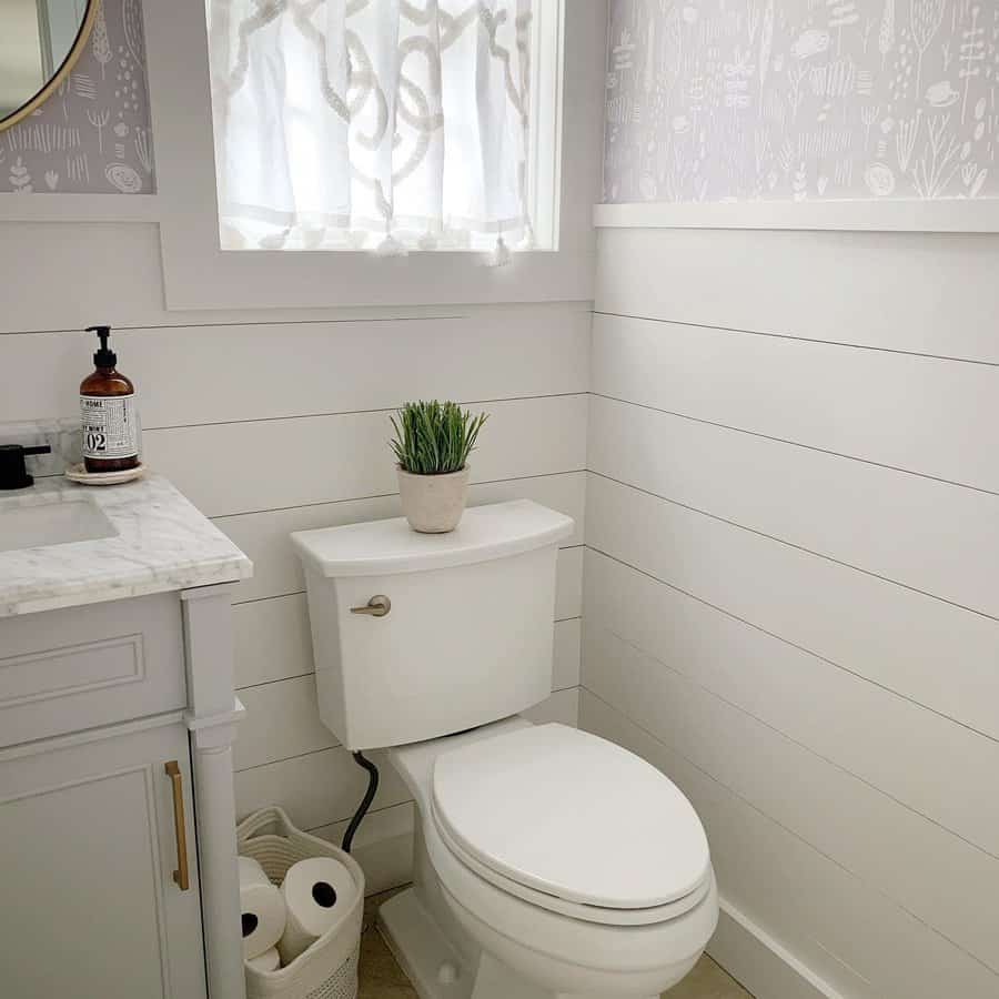 Fresh white bathroom with shiplap wainscoting and patterned window