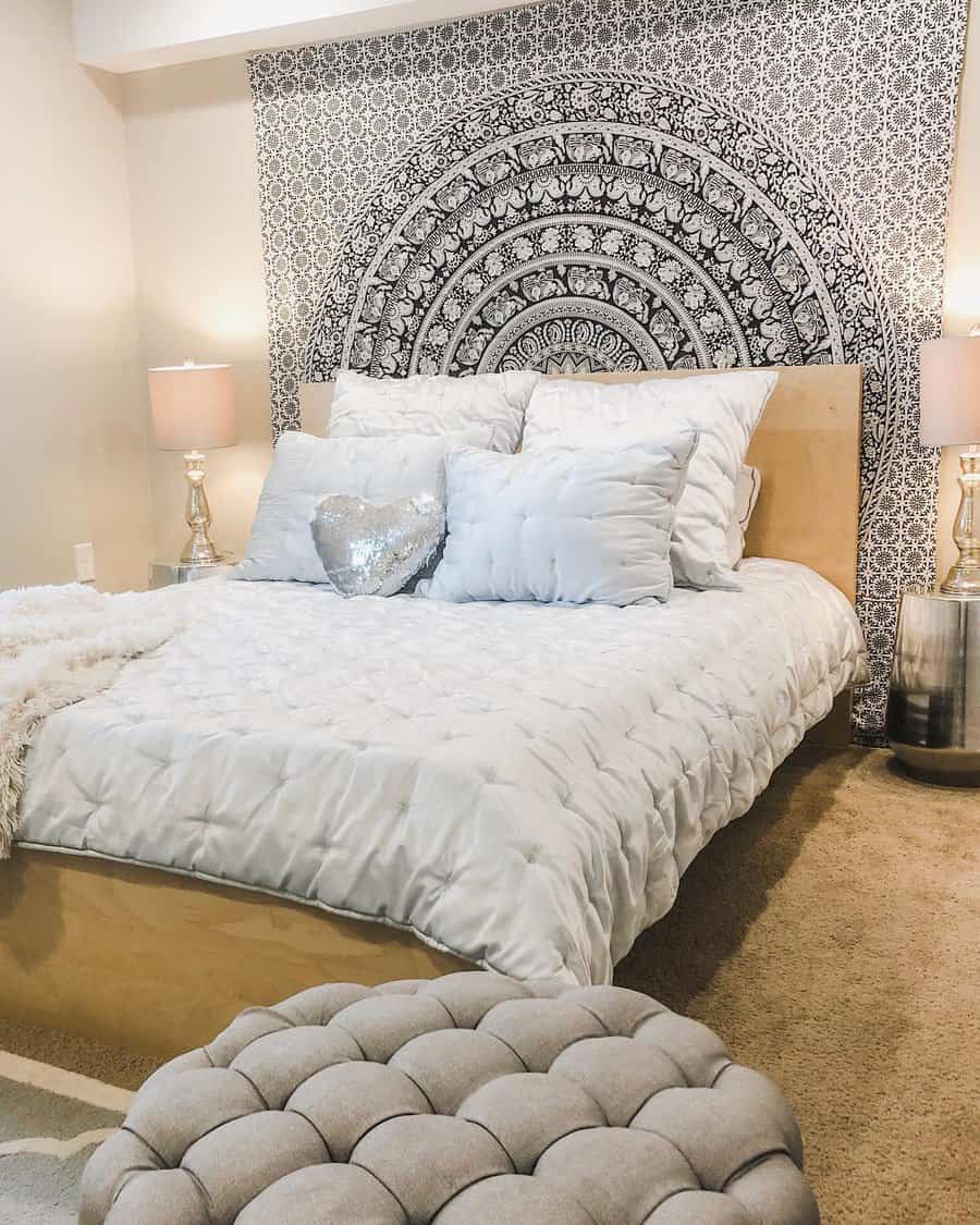 Stylish bedroom with mandala tapestry and tufted ottoman