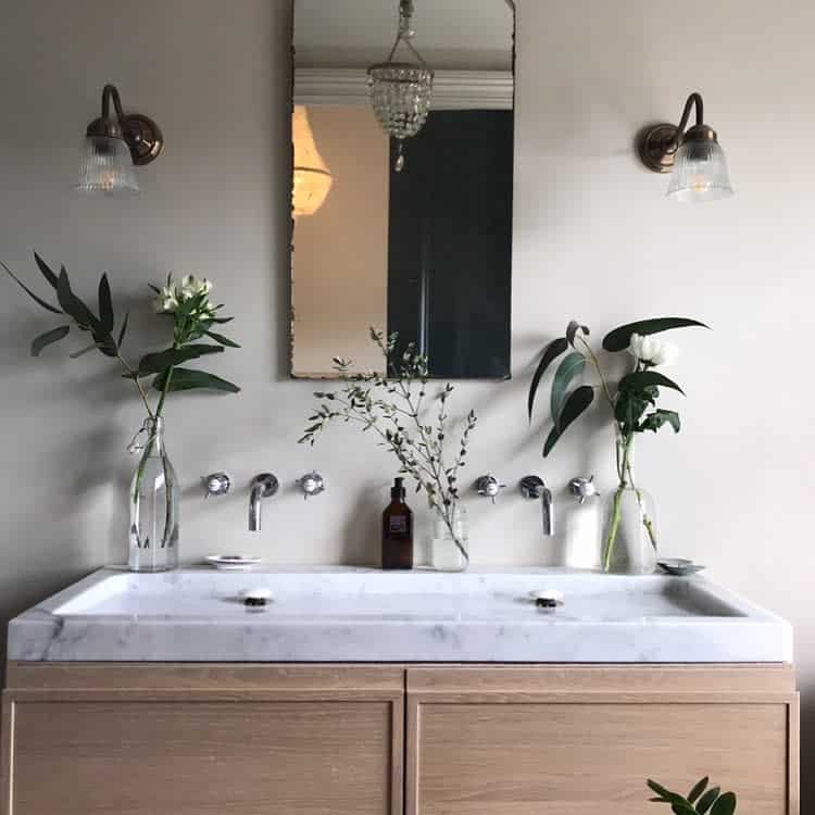 Vanity bathroom with wall-mounted lighting