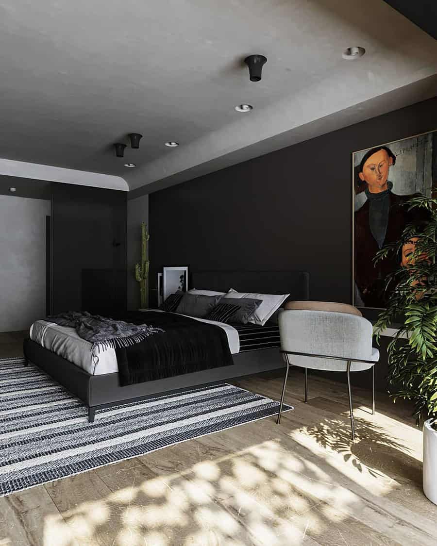 Moody black bedroom with modern furniture, bold wall art, indoor plants, and natural light streaming onto a striped rug and wood floors