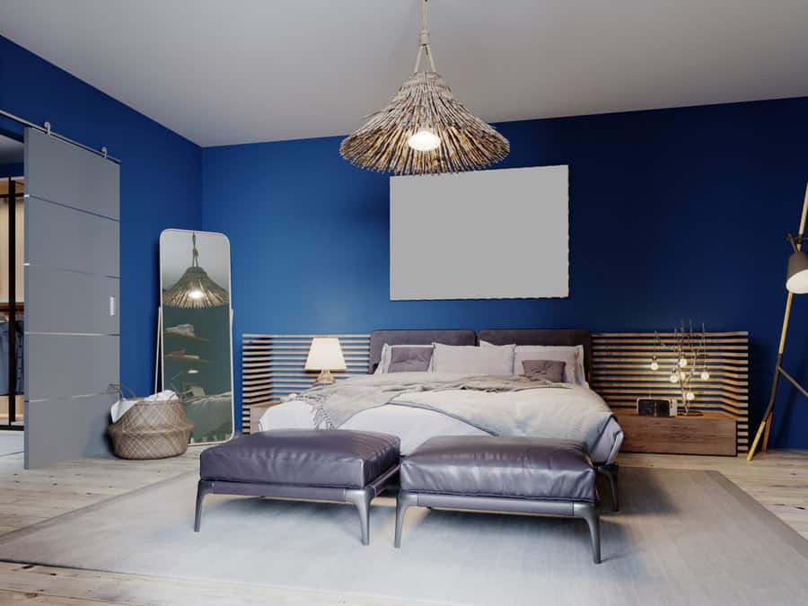 blue bedroom with rattan shade lamp