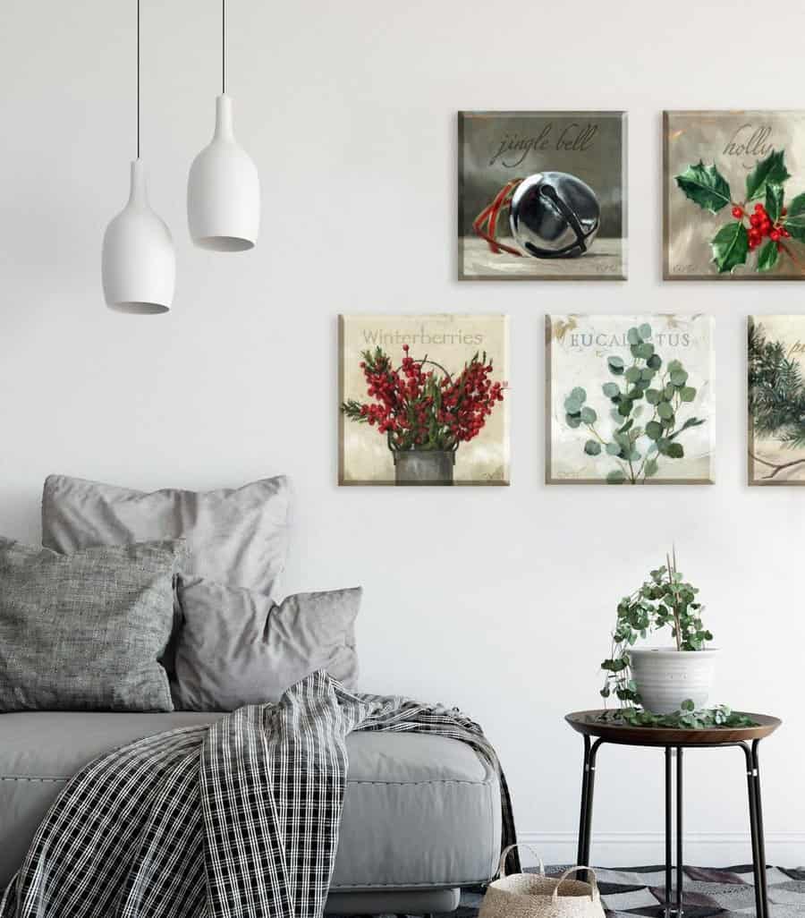 Minimalist living room with gray couch, festive wall art, and white hanging lights