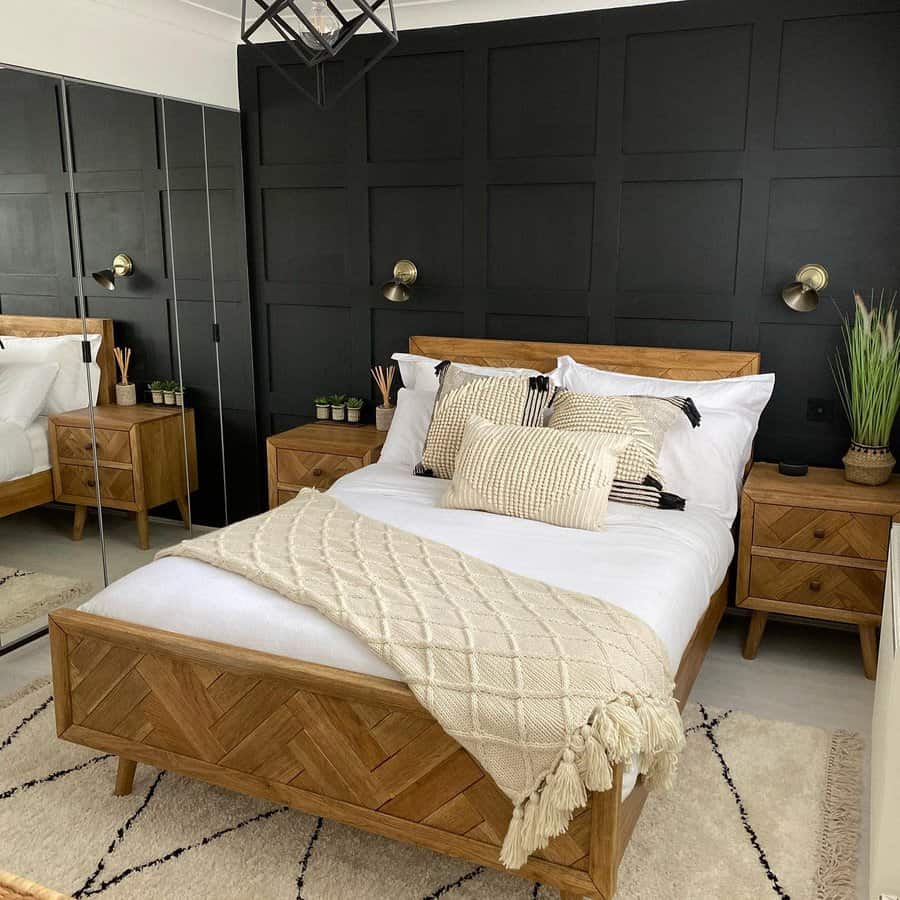 Cozy bedroom with a wooden bed, white and beige bedding, and a dark feature wall flanked by matching wooden nightstands