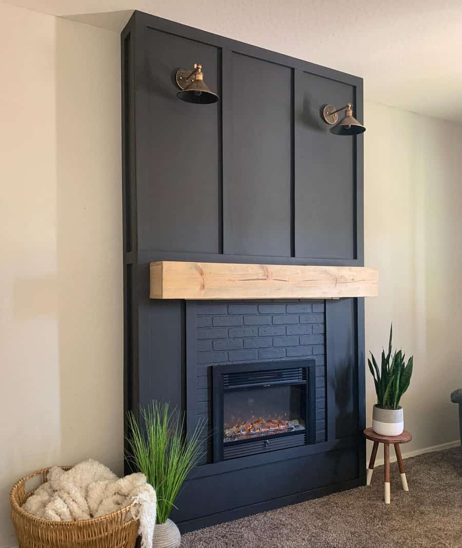 A modern wall-mounted fireplace with a sleek black brick surround, a wooden mantel, and industrial-style light fixtures, creating a clean and contemporary focal point