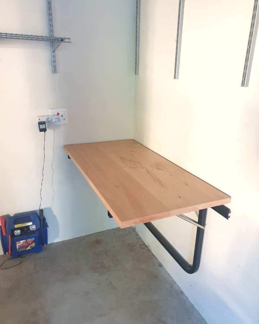 Wall mounted foldable workbench in a clean garage space