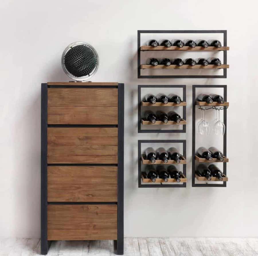 Wooden wine rack and cabinet with bottles and hanging glasses in a modern, minimalist room with white walls and wooden flooring