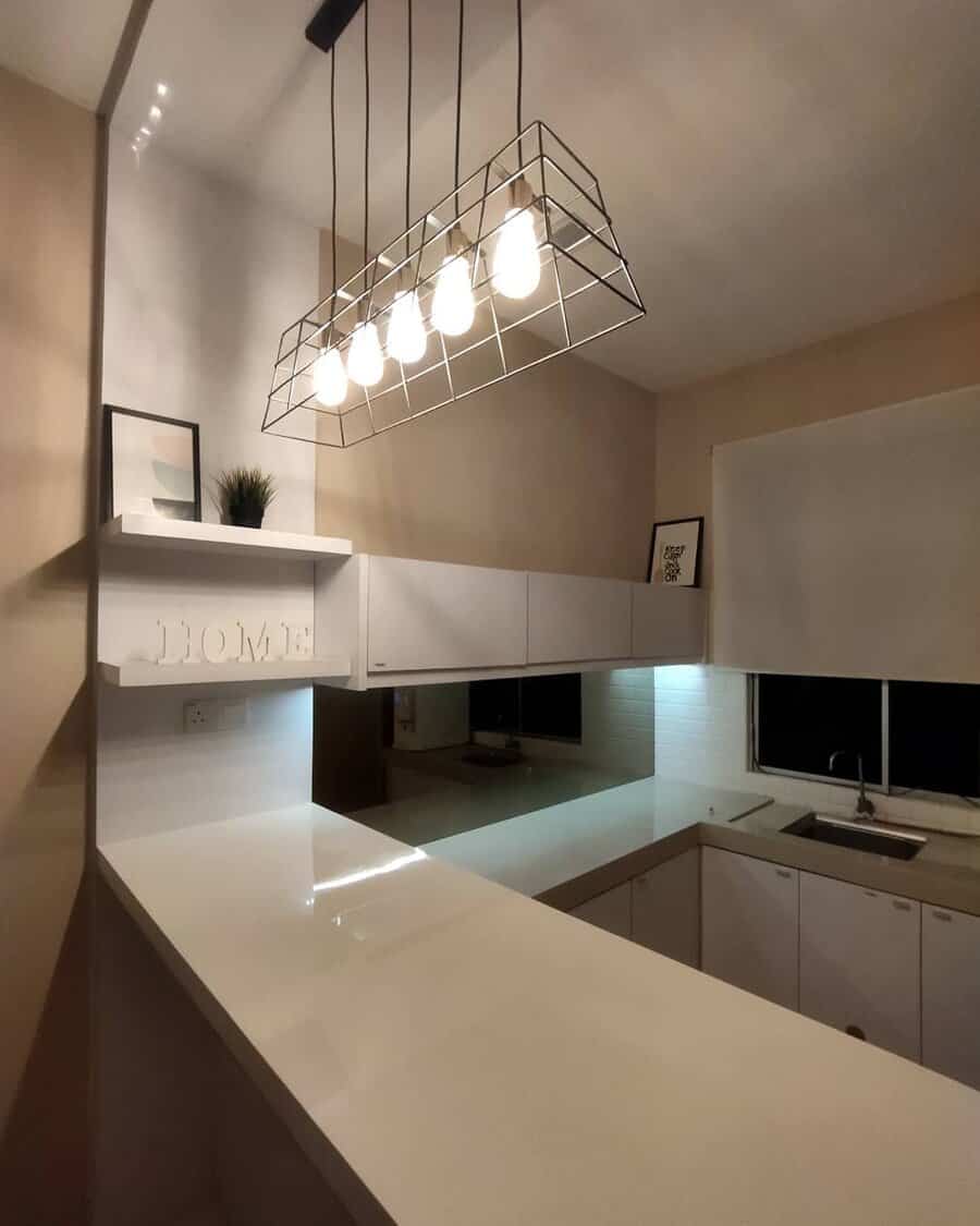 Modern kitchen with geometric light fixture and bar counter