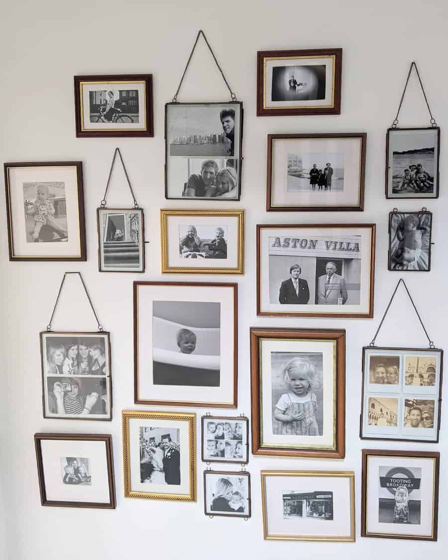 A collage of black and white family photos in various frames arranged on a white wall