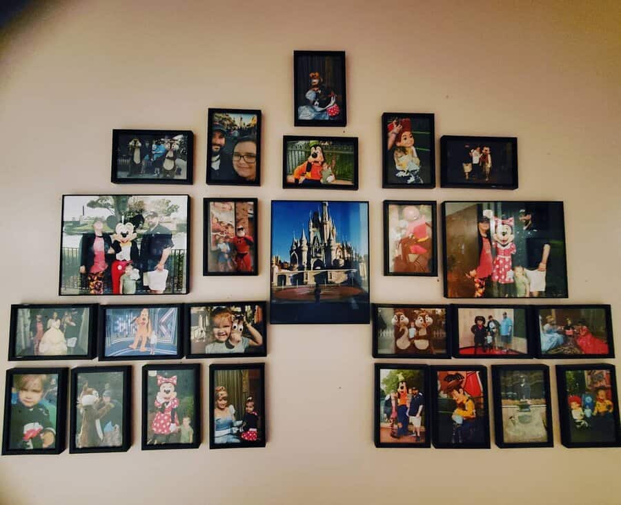 A wall collage of framed photos featuring people at a Disney theme park, with characters like Mickey and Minnie Mouse