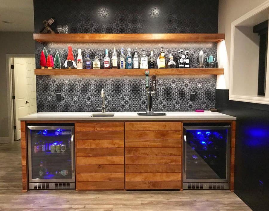 Home bar with fridge and assorted liquor bottles