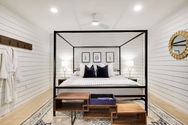 Crisp white bedroom with canopy bed and nautical accents