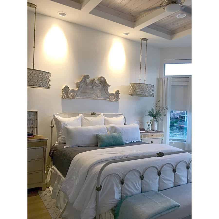 Elegant bedroom with ornate headboard and pendant lights