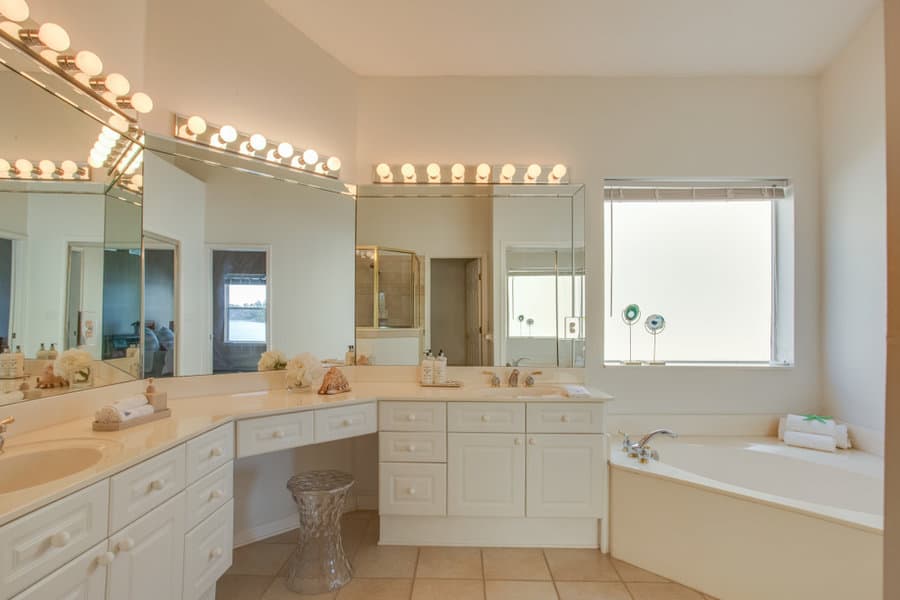 white beach bathroom with wide mirror