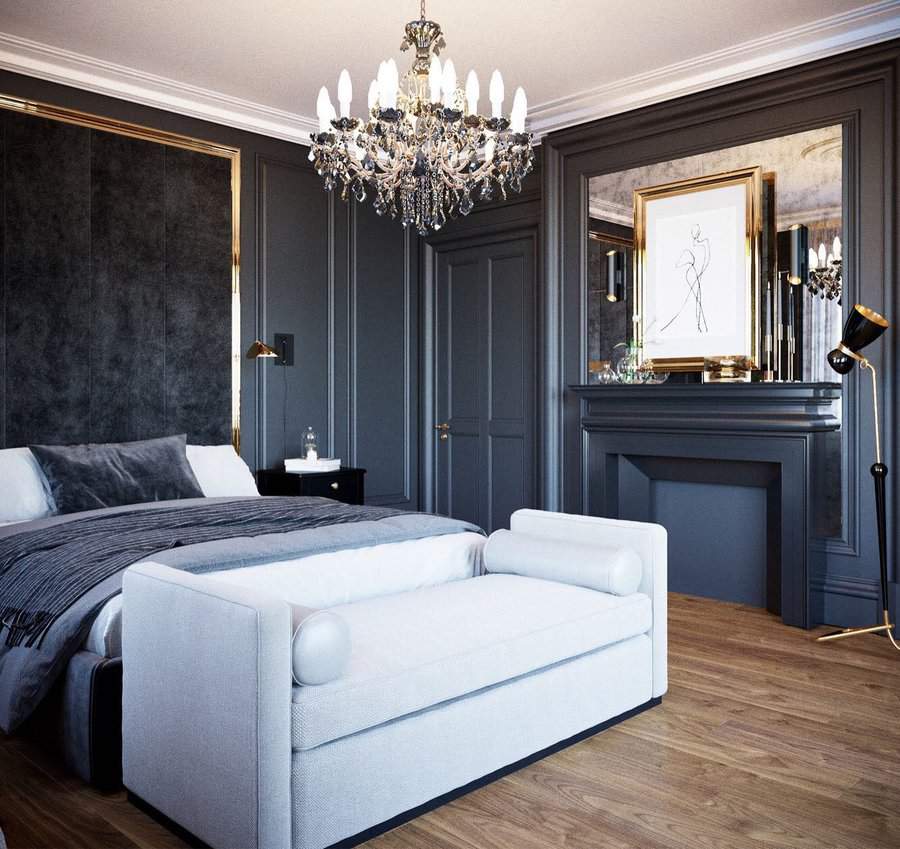 Elegant black bedroom with gold accents, crystal chandelier, and a white bench adding contrast to the dark, luxurious setting