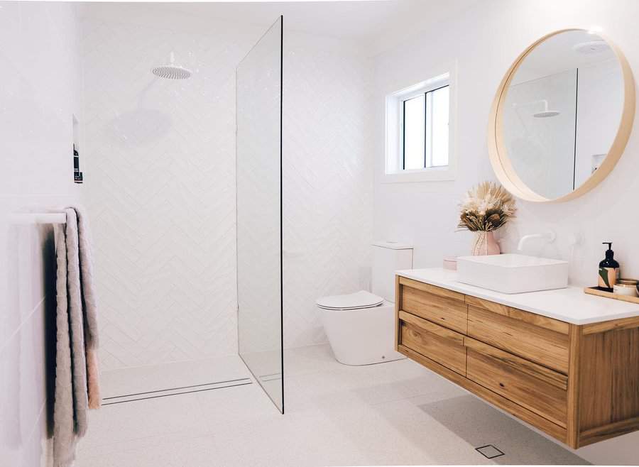 Modern bathroom with wooden vanity and glass shower