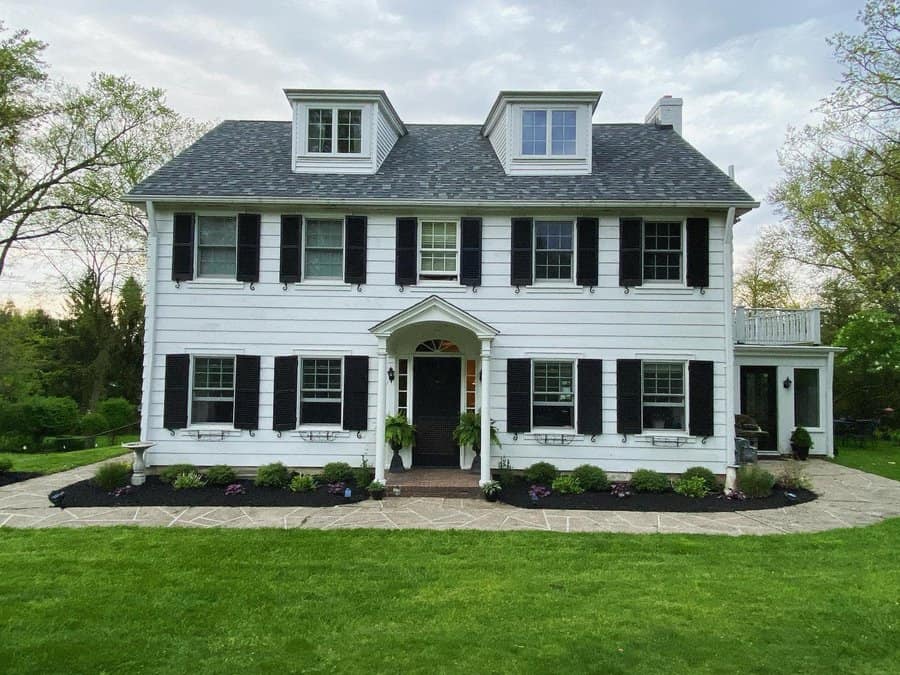 White colonial house with shiplap walls