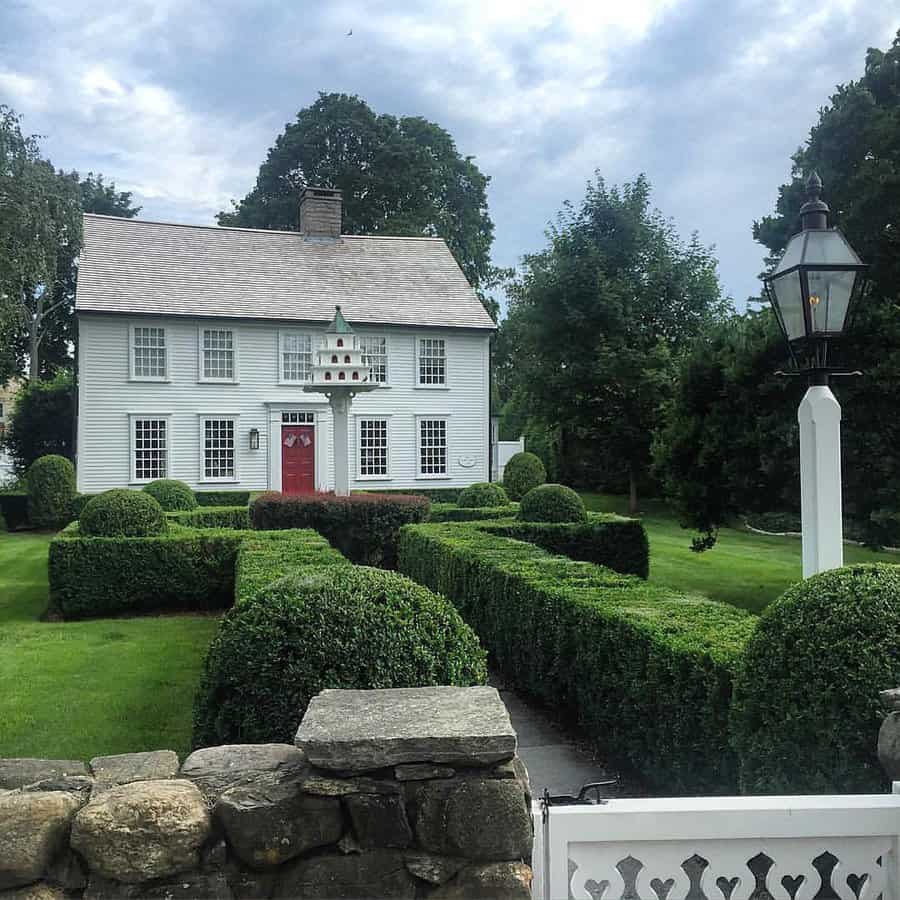 White colonial house with shiplap walls