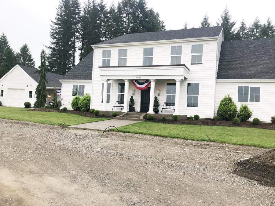 Colonial house with grass lawn