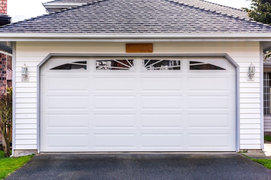 Rustic house with white wooden garage door