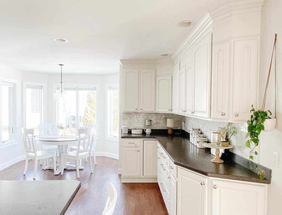 White cabinets with black countertops